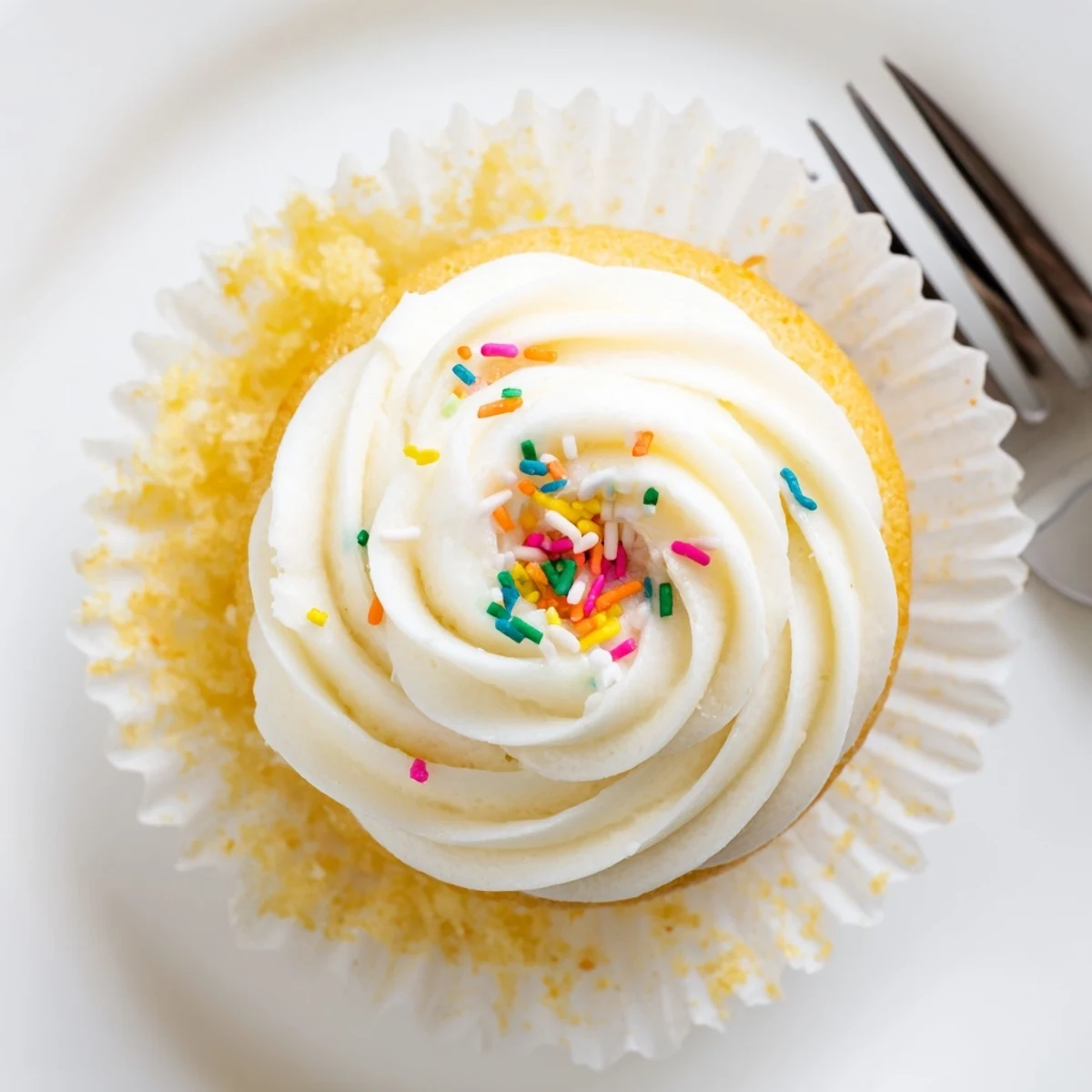 Homemade vanilla cupcakes with golden crumb and tall swirls of vanilla bean buttercream