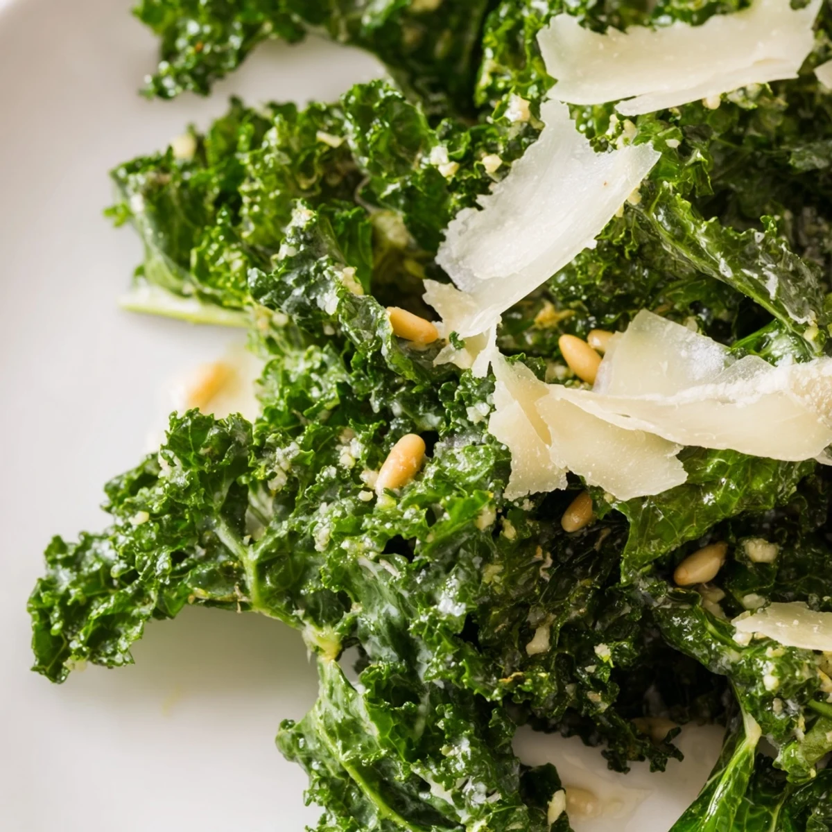 Vibrant Garlic Lemon Parmesan Kale Salad topped with golden nuts in a rustic bowl