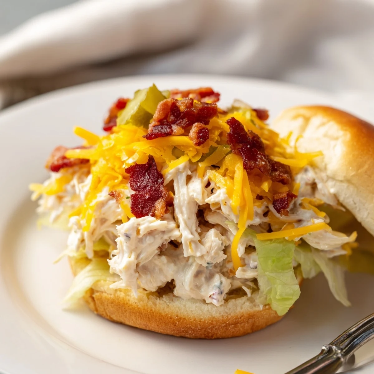 Creamy baked Crack Chicken Sandwiches spooned from casserole, perfect with iced tea