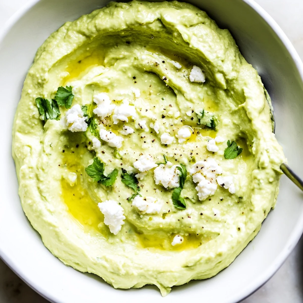 Velvety Creamy Avocado Feta Dip brightened with lime, sprinkled cilantro.