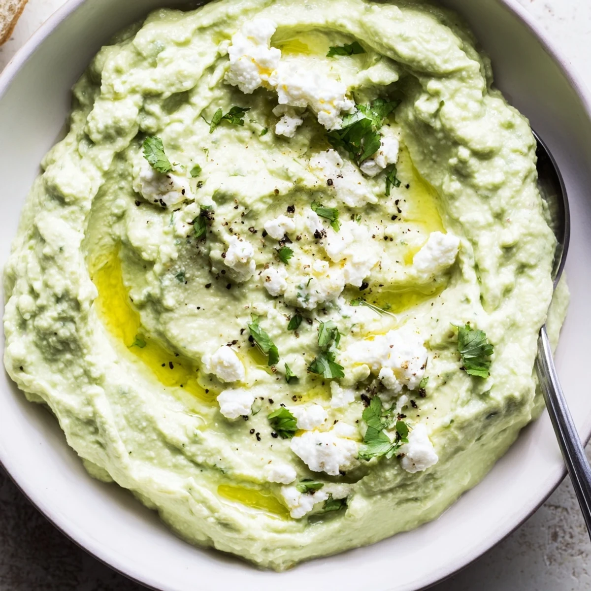 Creamy Avocado Feta Dip served with crisp veggie sticks, hint of garlic.