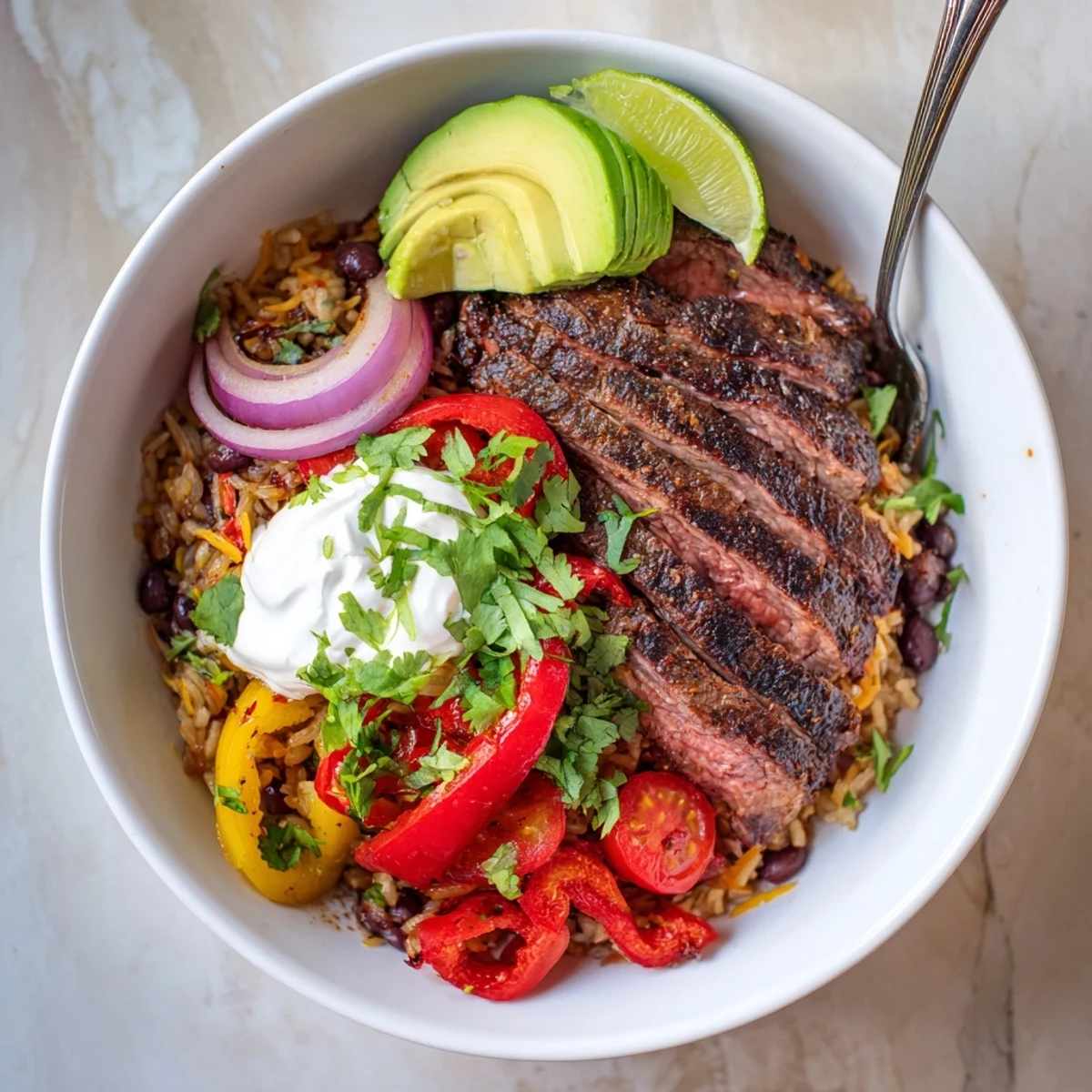 Family-style serving of Steak Fajita Power Bowls with lime wedges and chips.