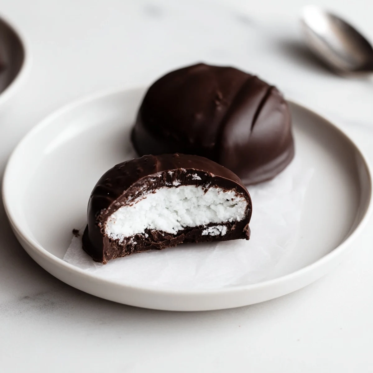 Homemade Peppermint Patties revealing creamy mint center, perfect after-dinner treat