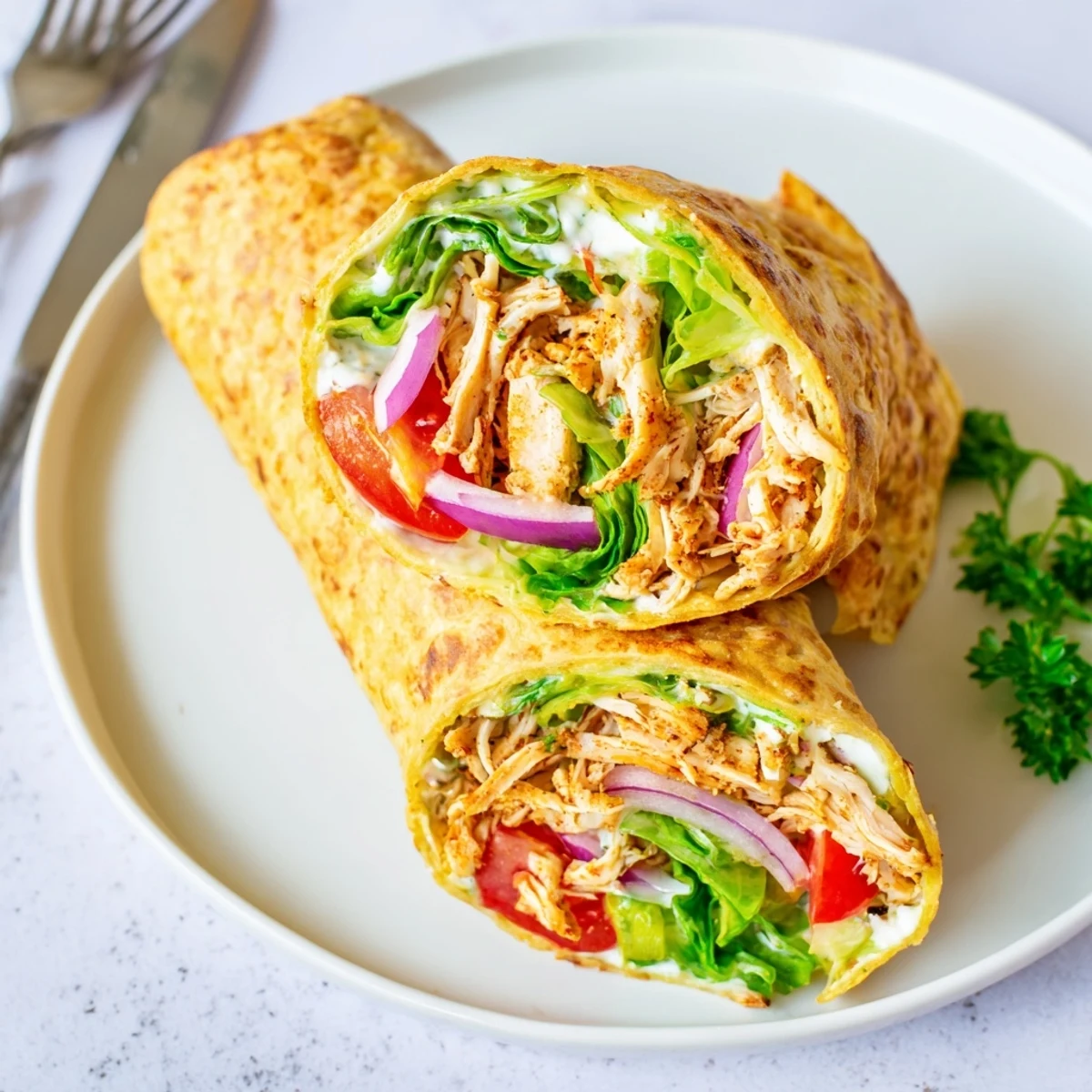Protein-packed cottage cheese flatbread wrap featuring juicy spiced chicken and colorful toppings