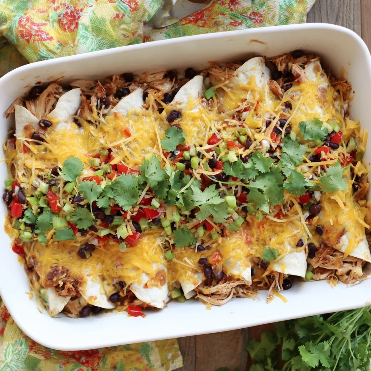 Baked chicken taco lasagna layers featuring tender shredded chicken beans and melted cheddar cheese