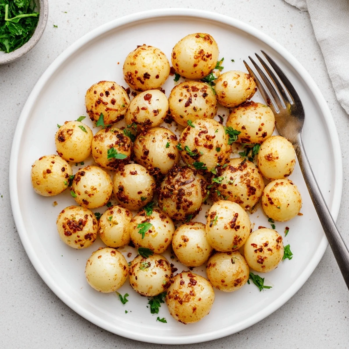 Air fried pearl onions glistening with olive oil and smoked paprika coating